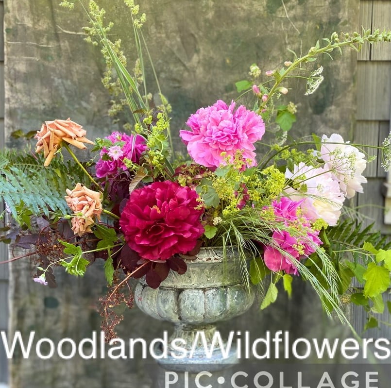 Floral arrangement in a woodland and wildflowers style. 