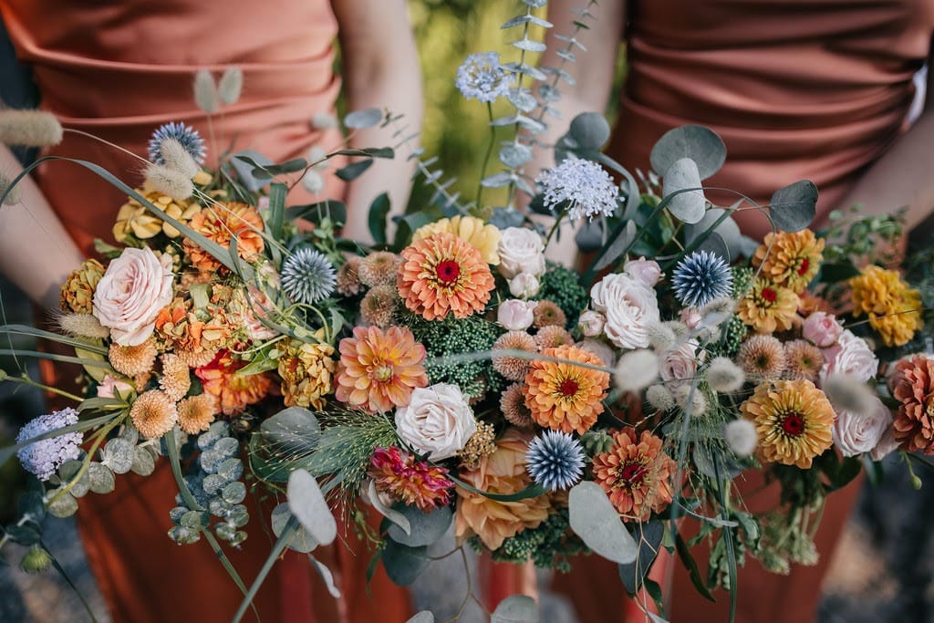 Close up of two bouquets held by two bridesmaids